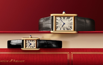 Cartier Valentines campaign with Mens &amp; Ladies Tank watches on red covered books image